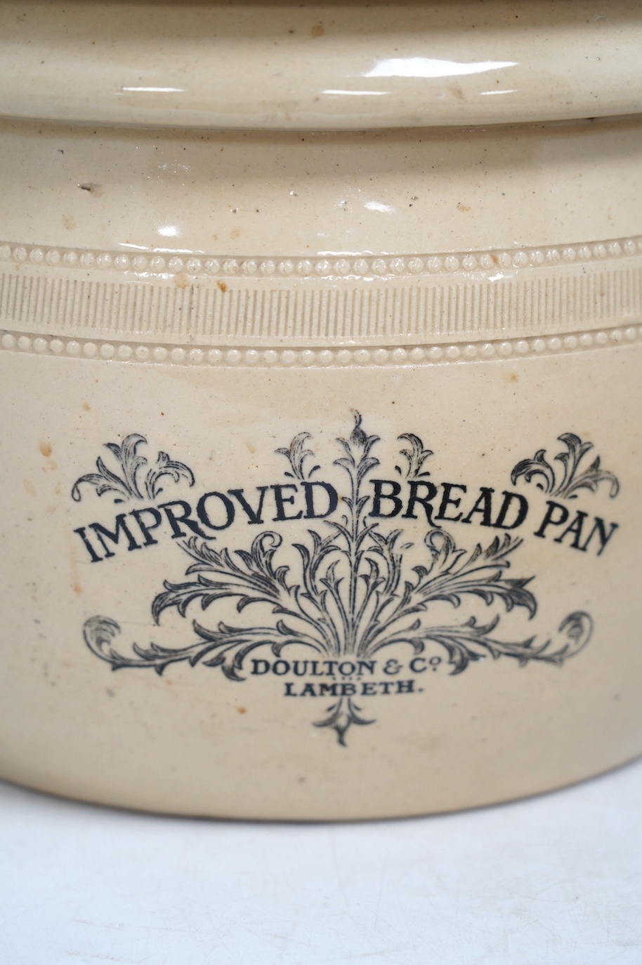 A Victorian Doulton Lambeth Improved Bread Pan, 32cm high, together with a Victorian pottery circular Margarine stand, 30cm diameter. Condition - poor to fair